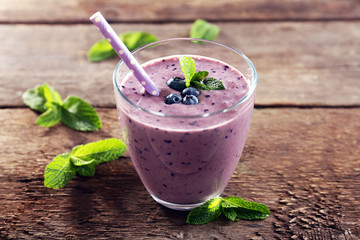 Sticker - Tasty blueberry yogurt decorated with berries and mint on wooden background