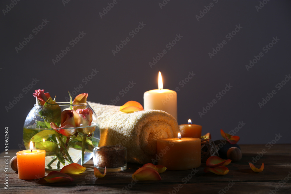 Beautiful spa composition with alight candles on wooden table