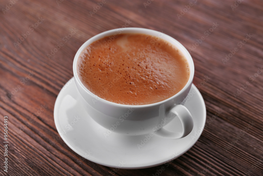 Cup of coffee on wooden background