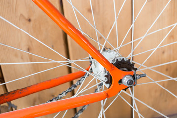 Wall Mural - bicycle parked with wood wall, close up image part of bicycle