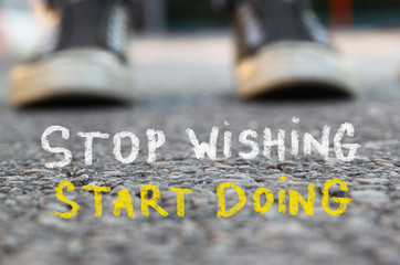 low angle image of asphalt road and person sneakers with the text stop wishing start doing
