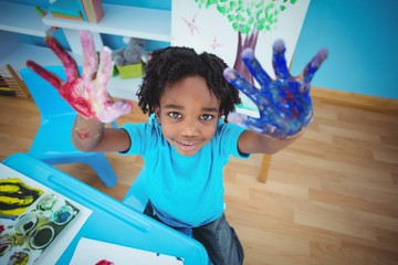 Wall Mural - Happy kid enjoying arts and crafts painting