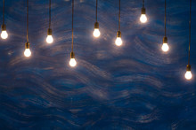 Light Bulbs On Blue Textured Background