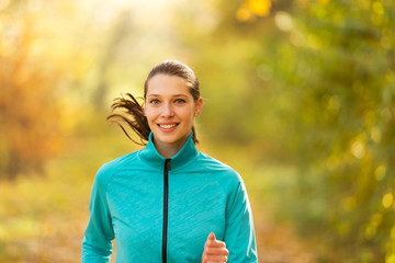 Canvas Print - Female fitness model training outside and running.