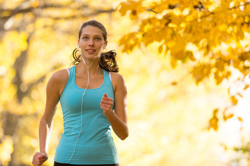 Canvas Print - Female fitness model training outside and running.