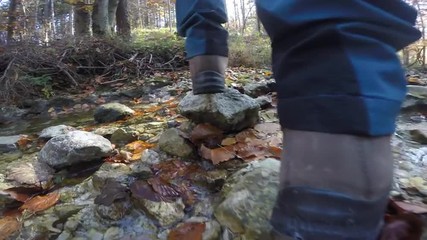 female hiker walking in creek