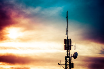 Wall Mural - Silhouette shot of television and radio antenna pylon with cloud