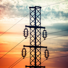 Wall Mural - Silhouette shot of electricity pylons with cloudy sky