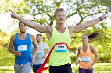 Wall Mural - happy young male runner winning on race finish