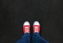 Feet Wearing Red Shoes On Black Background With Space For Text