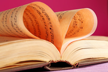 Sticker - Book pages curved into heart shape on pink background