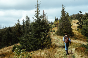 beautiful happy stylish traveling girl in the mountains on a bac