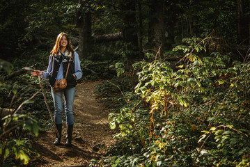 beautiful happy stylish traveling girl in the mountains on a bac