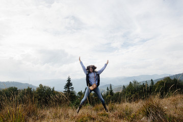 Canvas Print - beautiful happy stylish traveling girl  in the mountains on a ba