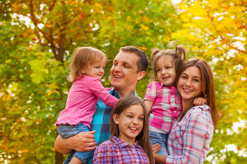 Poster - Happy family portrait with little girls outside