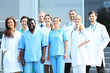 © Africa Studio - Smiling team of young doctors against hospital entrance