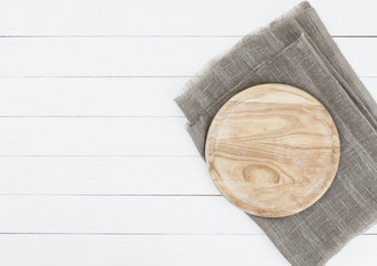 Wall Mural - Cutting board on vintage wooden background. Round cutting board on white wooden table