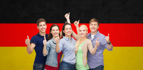 Wall Mural - group of smiling students showing thumbs up