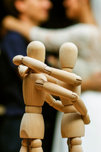 Wooden People Staying And Hugging, Wedding Couple  At Bokeh. People Relationship Concept