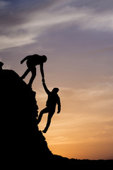 Wall Mural - Silhouette of helping hand between two climber