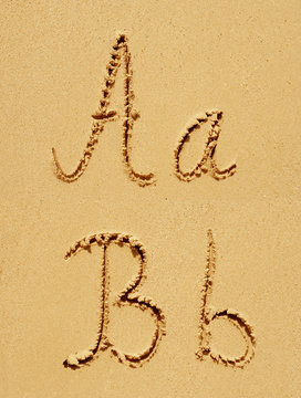Sand font or letter set or collection on an exotic beach near the sea in summer