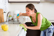 © JackF - Young woman cleaning in kitchen