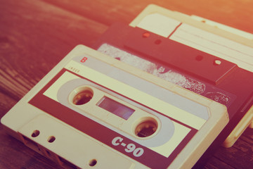 Wall Mural - close up photo of cassette tape over wooden table . top view. retro filtered
