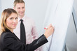 © glagoliev - Businesswoman is writing on the whiteboard