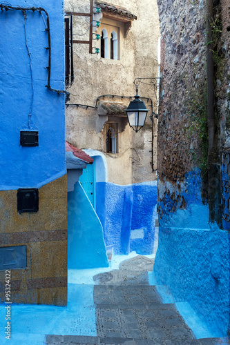 Narrow alley leading through the medina in Chefchaouen, Morocco.