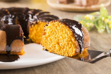 Carrot cake with chocolate and slice on the table