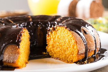 Wall Mural - Carrot cake with chocolate and slice on the table