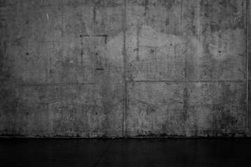 Grungy dark concrete wall and wet floor