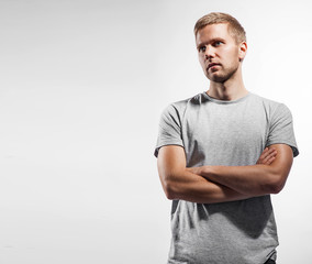 Athletic man in blank gray t-shirt on a white background