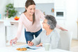 © auremar - Carer helping woman at home