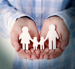 Wall Mural - Female hands holding toy family, closeup