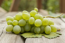 Bunch Of Green Grapes On Wooden Table