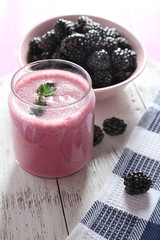 Wall Mural - Delicious berry smoothie with blackberries on table close up