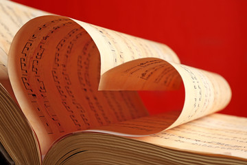 Sticker - Book pages curved into heart shape on red background