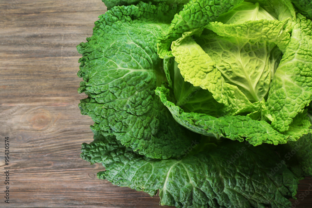 Savoy cabbage on wooden background, close up