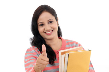 Wall Mural - Cheerful female student with thumbs up gesture