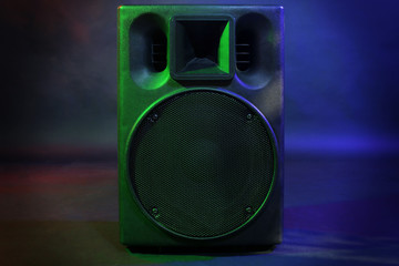 Black loudspeaker on dark background