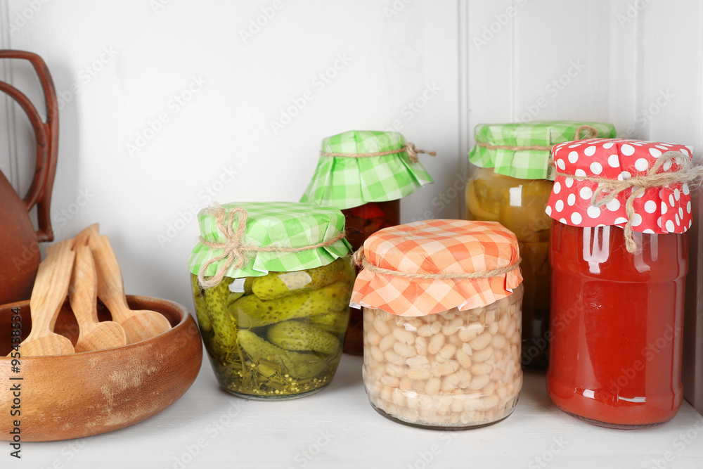 Jars with pickled vegetables on shelf