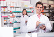 © JackF - pharmaceutists at reception of drugstore ready to help
