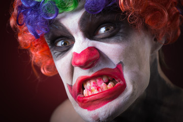 Evil Spooky Clown Portrait on dark background. expressive man