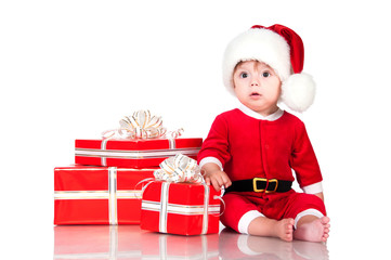 Thoughtful little Santa Claus with presents. Isolated on white b