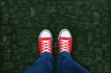 Feet Wearing Red Shoes On Black Background With Business Plan