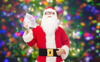 Canvas Print - man in costume of santa claus with euro money