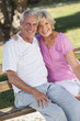 © Darren Baker - Happy Senior Couple Sitting on Bench in Sunshine