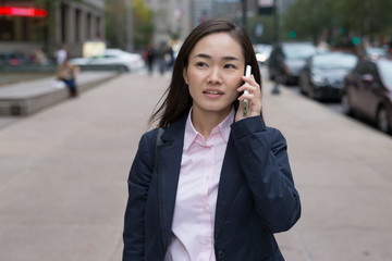 Sticker - Asian business woman in New York City talking on cell phone