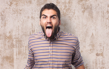 portrait of a young man showing his tongue